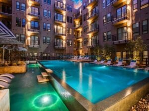 night time photo of a apartment building and pool